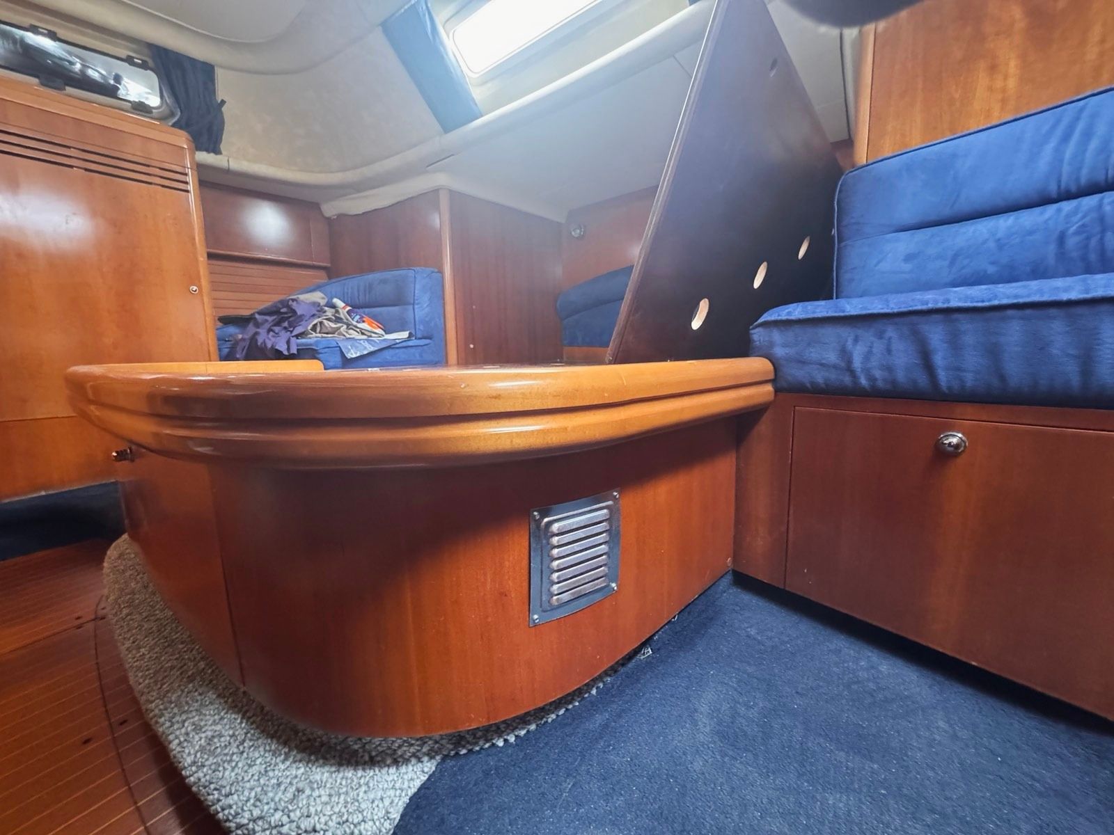 The curved wooden bed base with a ventilation grille